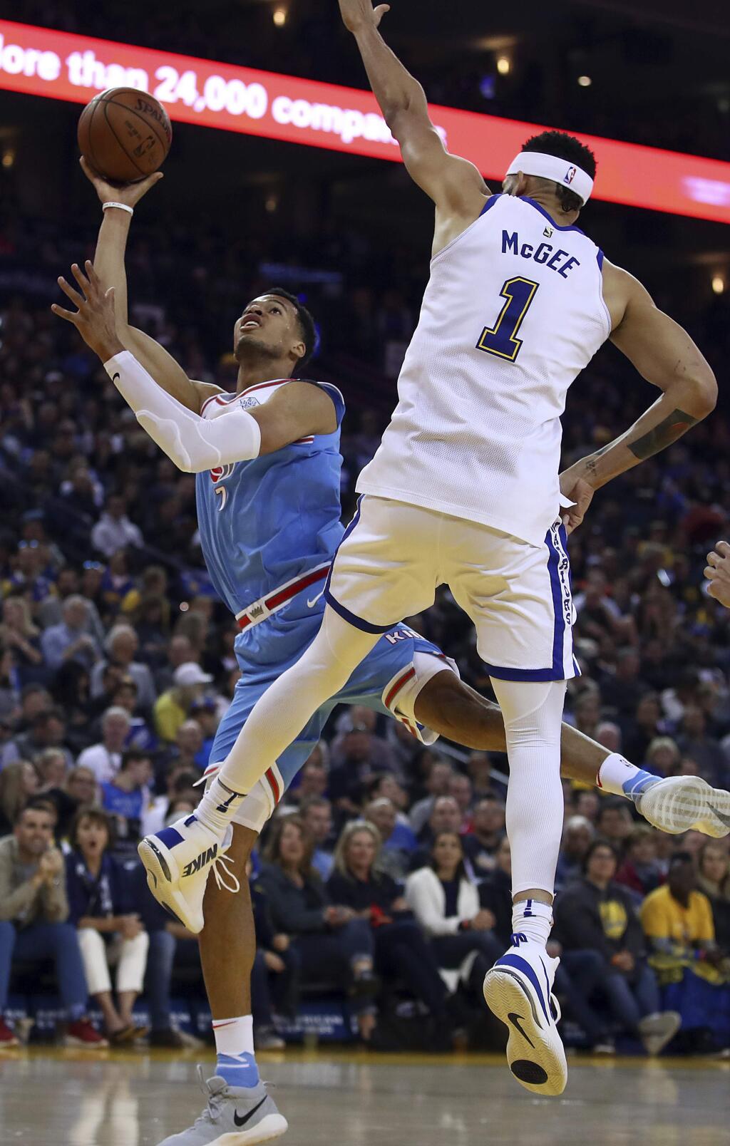 Sacramento Kings' Skal Labissiere, left, shoots against Golden State Warriors' JaVale McGee, right, during the first half of an NBA basketball game on Friday, March 16, 2018, in Oakland, Calif. (AP Photo/Ben Margot)