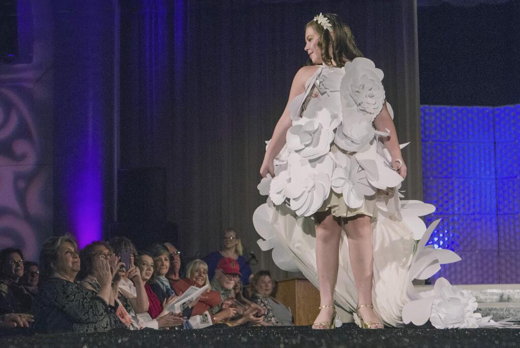 Sophia Carlsson designed and modeled 'Flower Diva,' made from repurposed flower decorations, at the Sonoma Community Center's Trashion Fashion Show last Saturday, March 19. High couture made from lowly rubbish graced the catwalk at the Vets Building before an appreciative crowd. (Photos by Robbi Pengelly/ndex-Tribune)