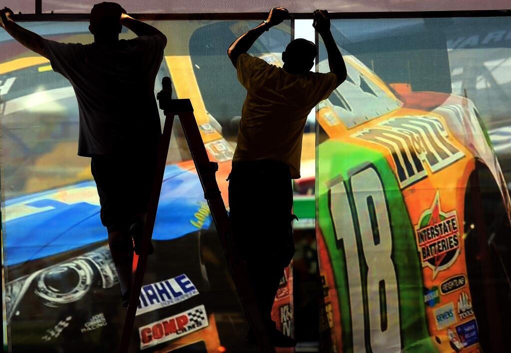 A display is prepared at the Save Mart Super Markets display in the paddock area of Sonoma Raceway Thursday June 25, 2015 in Sonoma. (Kent Porter / Press Democrat) 2015