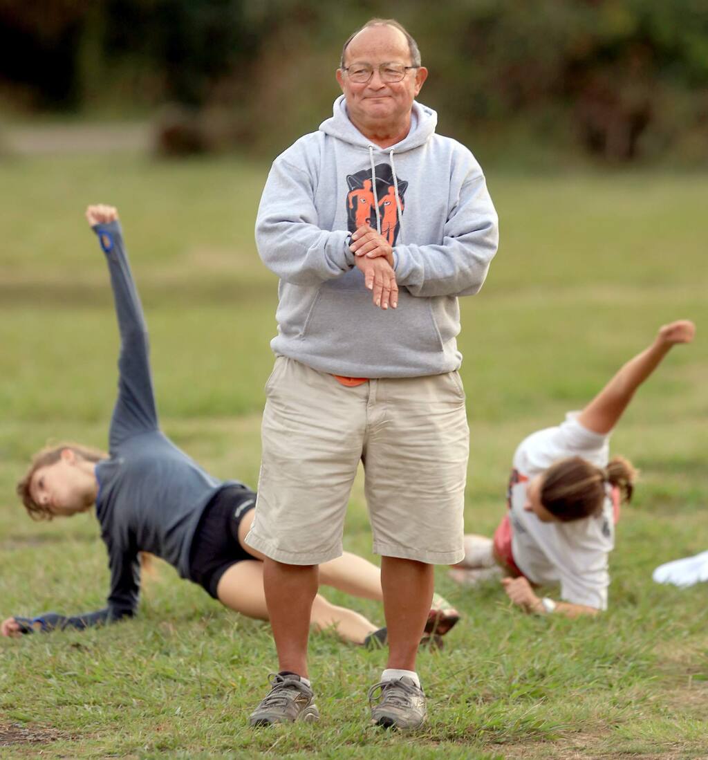 Santa Rosa High School cross country coach Doug Courtemarche, times his runners during a workout at Spring Lake, Monday, Nov. 2, 2015 (Kent Porter / Press Democrat)
