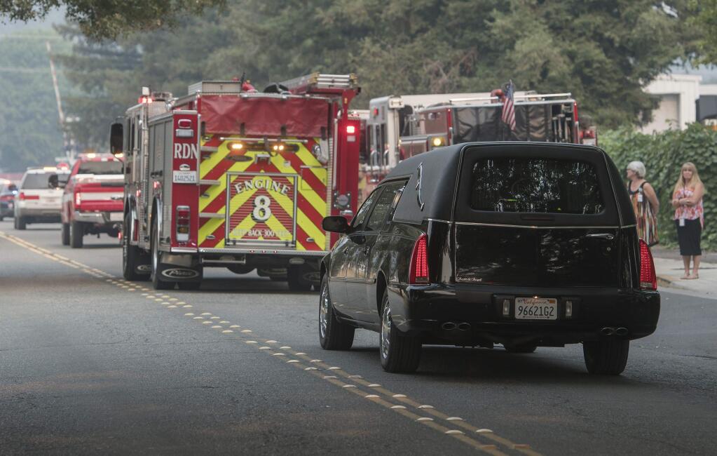 A procession for Redding fire inspector Jeremy Stoke, who was killed in the Carr fire. He is one of three firefighters killed so far this year in California wildfires. (MICHAEL BURKE / Associated Press)
