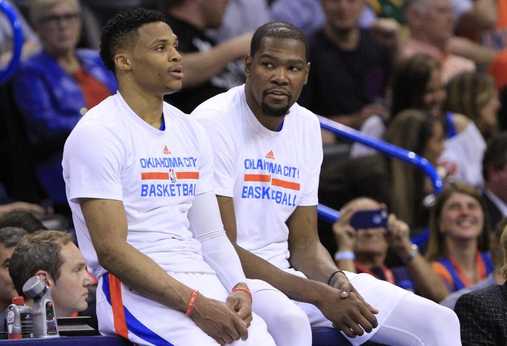 FILE - In this April 11, 2016, file photo, Oklahoma City Thunder's Russell Westbrook, left, and Kevin Durant talk during a timeout in the second half of an NBA basketball game in Oklahoma City, Okla. The next time Russell Westbrook walks into a locker room for a game, Kevin Durant will be there. Get ready for the perhaps the best subplot of All-Star Weekend. The former Oklahoma City teammates and now rivals play as Western Conference teammates Sunday night, Feb. 19, 2017. (AP Photo/Alonzo Adams, File)