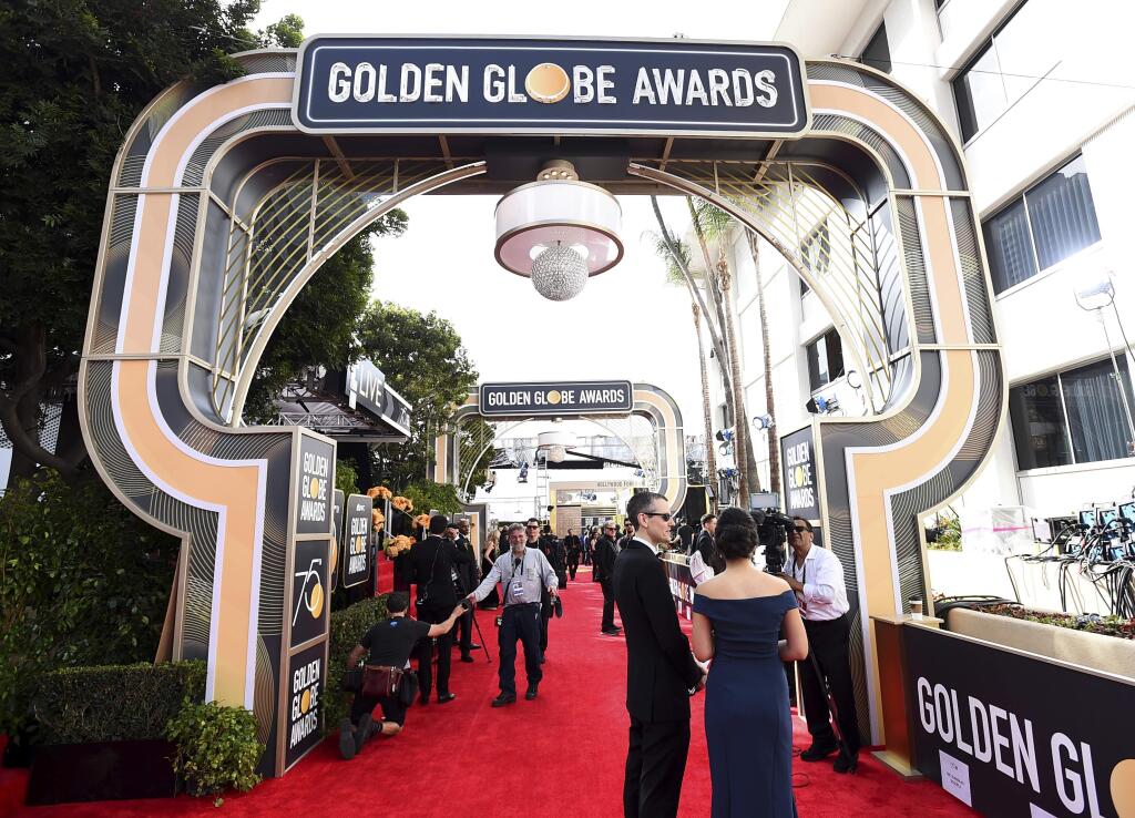 FILE - In this Jan. 7, 2018 file photo, media and crew appear on the red carpet at the 75th annual Golden Globe Awards in Beverly Hills, Calif. The Hollywood Foreign Press Association said Monday, July 23, that the 76th annual awards ceremony will be held Jan. 6, 2019. (Photo by Jordan Strauss/Invision/AP, File)