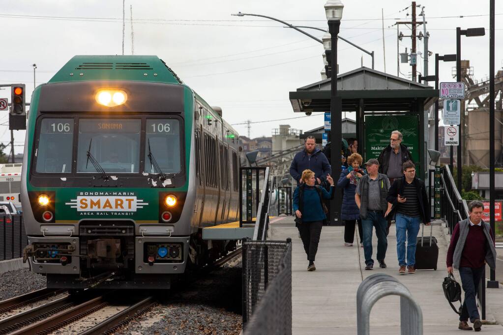 Passengers walk off the platform as the northbound SMART train departs downtown Petaluma, California, on Thursday, Feb. 13, 2020. (Alvin Jornada/The Press Democrat)