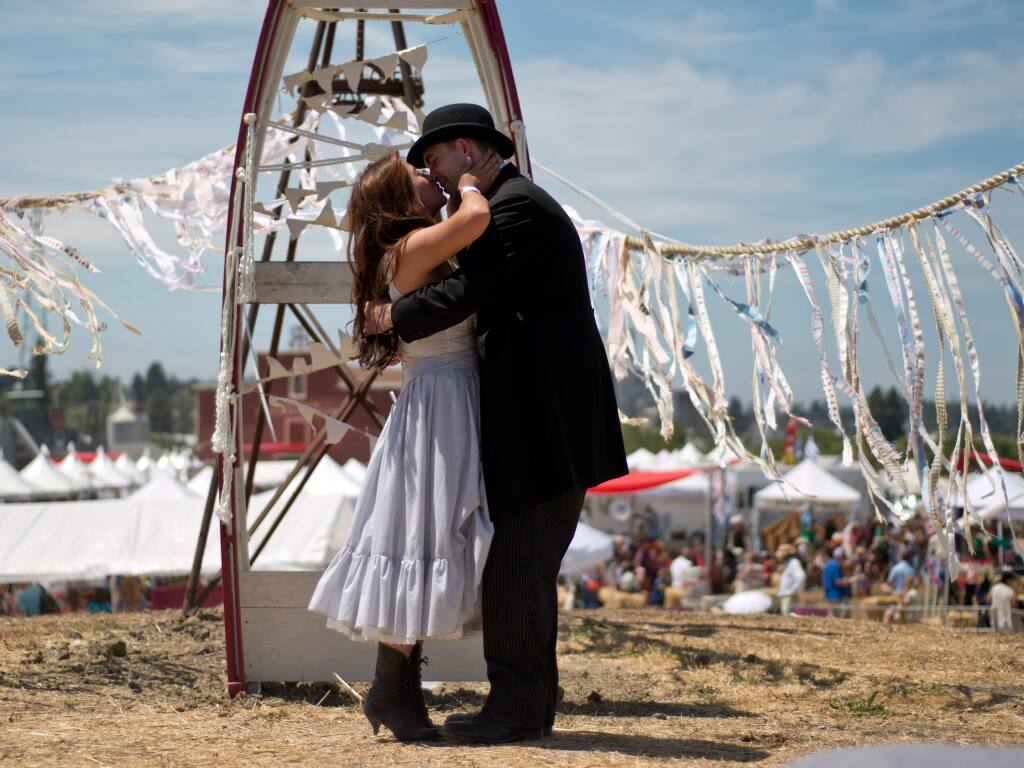 Newlyweds Jade and Michael Solis kiss after getting married at the Rivertown Revival in Petaluma, California, on July 19, 2014. (Alvin Jornada / For The Press Democrat)