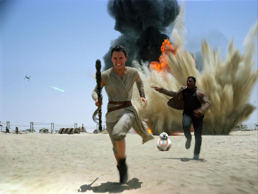 This photo provided by Disney shows Daisey Ridley as Rey, left, and John Boyega as Finn, in a scene from the new film, 'Star Wars: The Force Awakens.' The film will be available for purchase on Digital HD beginning on April 1, and on Blu-ray and DVD on April 5. (Disney/Lucasfilm via AP)