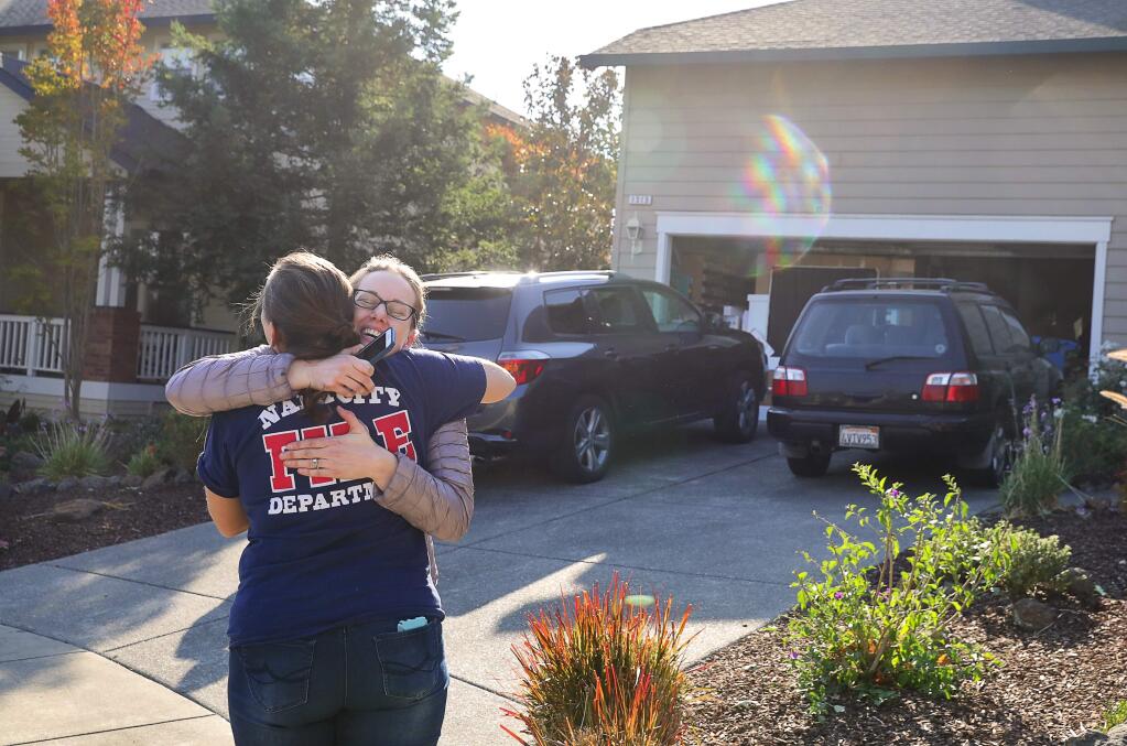 Laurel Chamness welcomes her neighbor Laura Krebs home to Branch Owl Place cul-de-sac in the Skyhawk subdivision, in Santa Rosa, after the evacuation order was lifted on Wednesday, October 18, 2017. (Christopher Chung/ The Press Democrat)