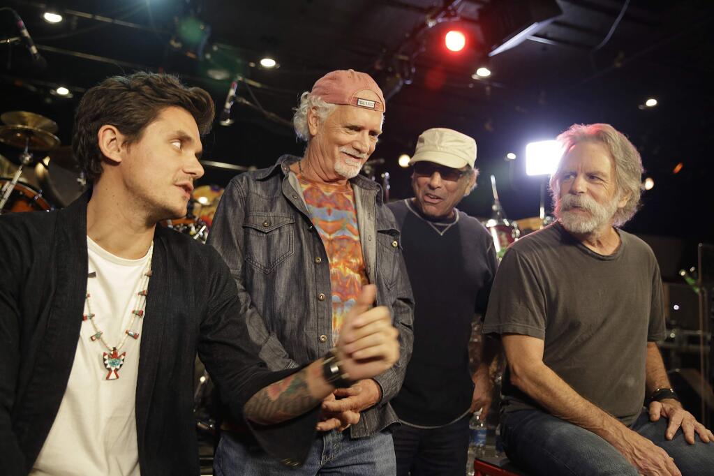 John Mayer, from left, Bill Kreutzmann, Mickey Hart and Bob Weir answer questions during an interview at a music studio Tuesday, Oct. 6, 2015, in San Rafael, Calif. Members of the Grateful Dead and John Mayer are giving away 10,000 free tickets to a concert next month. The veteran band and Mayer, who joined forces for the supergroup Dead & Company this summer, announced Monday that 5,000 fans will have a chance to win two tickets each to their Nov. 7 show in New York City. (AP Photo/Eric Risberg)