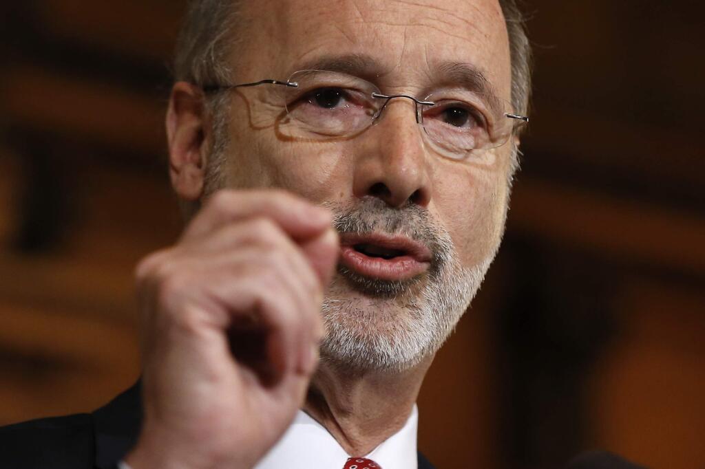 FILE - In this Dec. 29, 2015 file photo, Pennsylvania Gov. Tom Wolf speaks with members of the media at the state Capitol in Harrisburg, Pa. Many state and local governments across the country have suspended public records requirements amid the coronavirus pandemic, denying or delaying access to information that could shed light on key government decisions. (AP Photo/Matt Rourke, File)