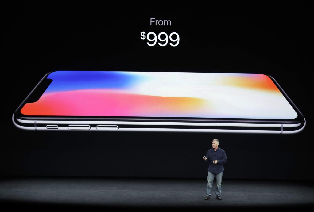 Phil Schiller, Apple's senior vice president of worldwide marketing, discusses features of the new iPhone X at the Steve Jobs Theater on the new Apple campus on Tuesday, Sept. 12, 2017, in Cupertino, Calif. (AP Photo/Marcio Jose Sanchez)