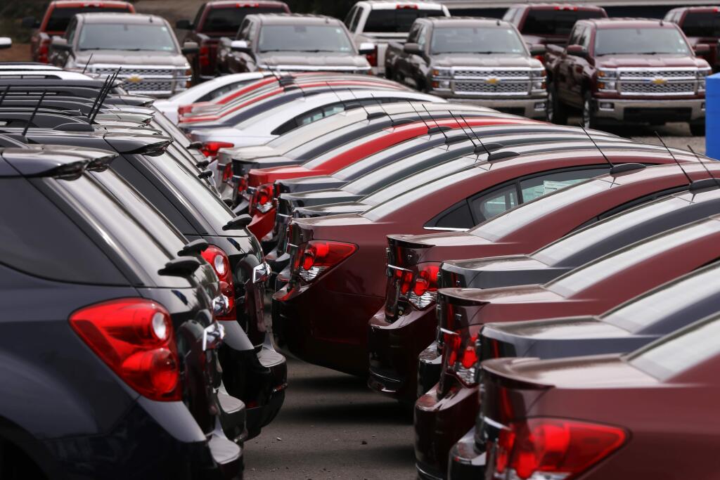 In this Monday, March 23, 2015 photo, Chevrolet vehicles are on display at a dealership in Gibsonia, Pa. Automakers release vehicle sales for March on Wednesday, April 1, 2015. (AP Photo/Gene J. Puskar)