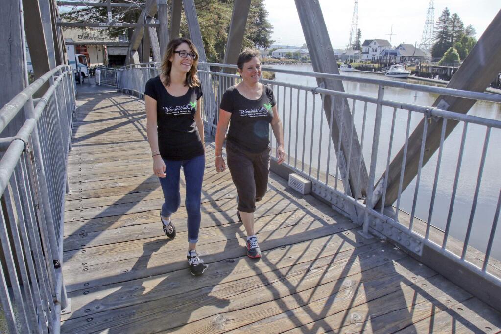 Joy Regan, right, founder of WomenWalking a business based on a website that helps women find other women walking prtners, walks with Madelyn Curcio in Petaluma on Tuesday, July 21, 2015. (SCOTT MANCHESTER/ARGUS-COURIER STAFF)