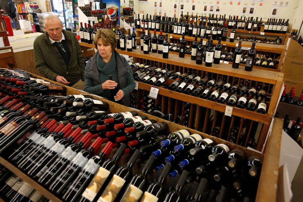 Marlene and Buzz McNaughton, visiting from Pittsburg, Pennsylvania, choose a selection of wines at Bottle Barn in Santa Rosa, California, on Wednesday, January 24, 2018. Wine shipments in volume increased 1.3 percent and overall wine sales increased almost three percent last year, according to the Unified Wine and Grape Symposium. (Alvin Jornada / The Press Democrat)