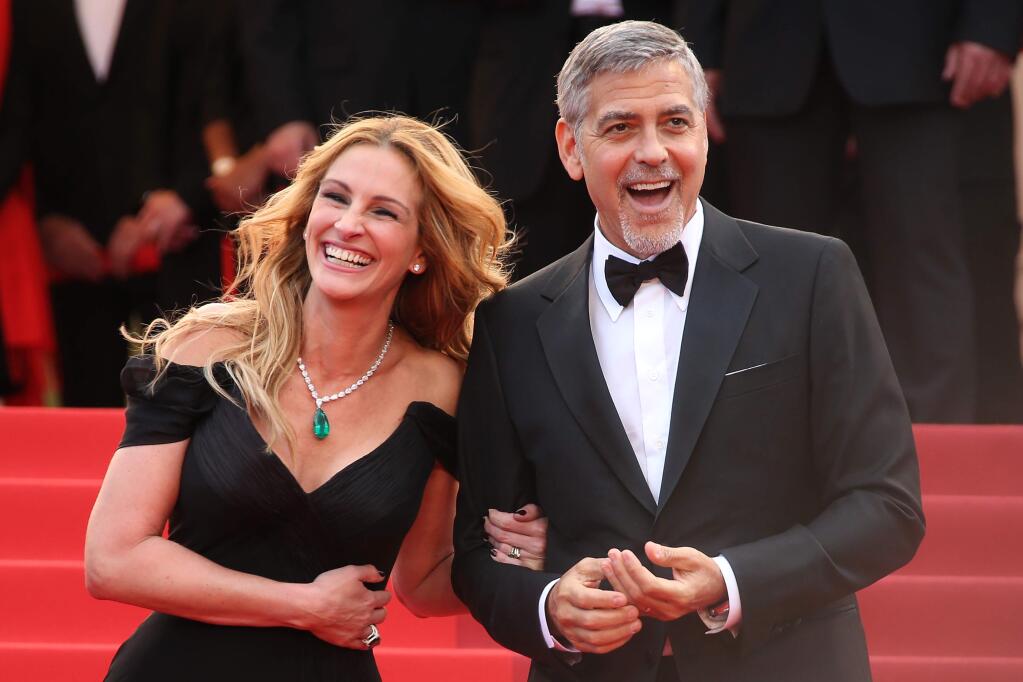 Actors George Clooney, right, and Julia Roberts pose for photographers upon arrival for the screening of the film Money Monster at the 69th international film festival, Cannes, southern France, Thursday, May 12, 2016. (AP Photo/Joel Ryan)