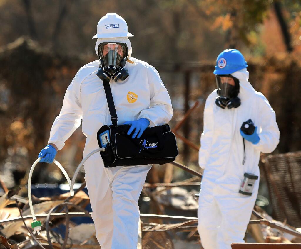 EPA hazardous materials survey team uses a mercury vapor analyzer, left, and devices for checking for radiation and volatile organic compounds in the ruins of the Coffey Park neighborhood on Wednesday, October 25, 2017. (photo by John Burgess/The Press Democrat)