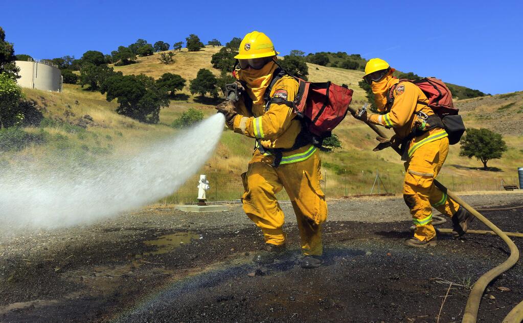 (File Photo) Hugo Camberos trains with Russel Griswold at the Cal Fire Seasonal Firefighter Academy in Yountville on Tuesday, April 14, 2015. (John Burgess/The Press Democrat)