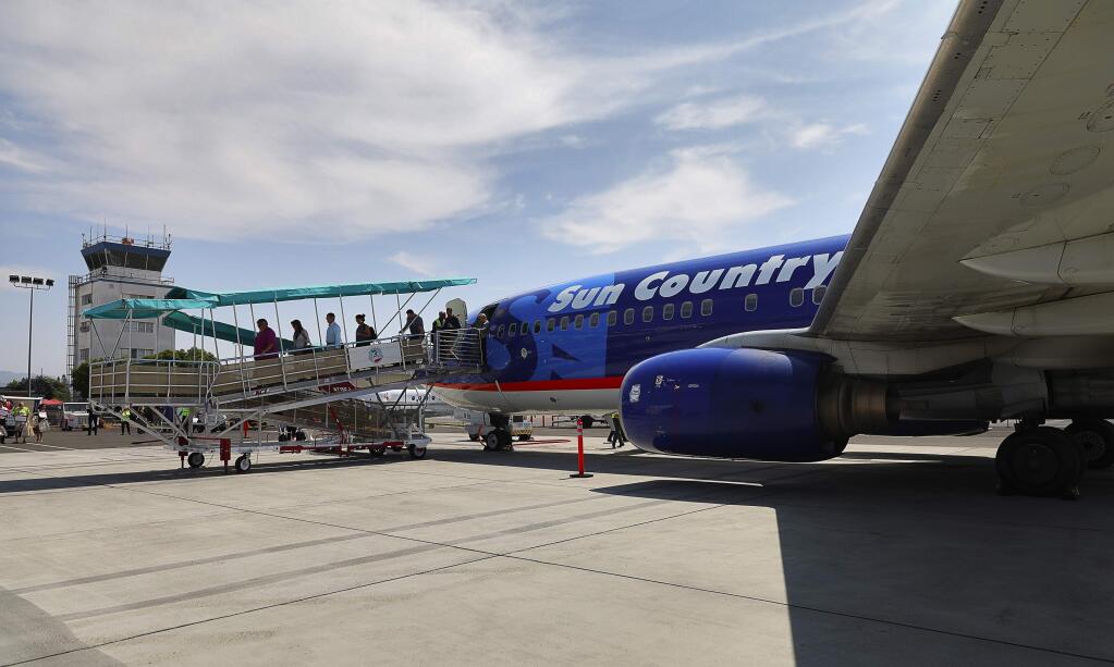 Passengers arrive on Sun Country Airlines' first flight from Minneapolis to Charles M. Schulz-Sonoma County Airport in Santa Rosa on Thursday, Aug. 24, 2017. (Christopher Chung/ The Press Democrat)