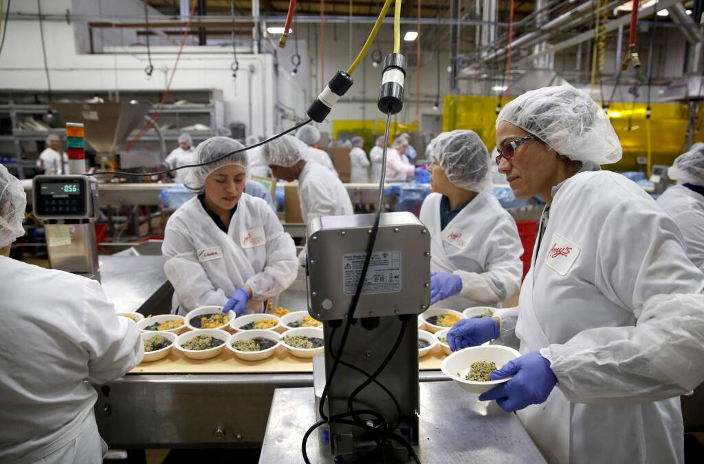 Amy's Kitchen team leader Gricelda Barajas Barragan, right, manages a line of employees making quinoa bowls at the Santa Rosa production plant on Wednesday, March 11, 2015. (BETH SCHLANKER/ The Press Democrat)
