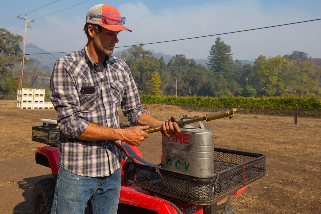 Justin Miller of Garden Creek Vineyards shows one of the back pumps he and his vineyard workers used to protect his winery when the Kincade Fire erupted, in Geyserville, California, on Friday, October 25, 2019. (Alvin Jornada / The Press Democrat)