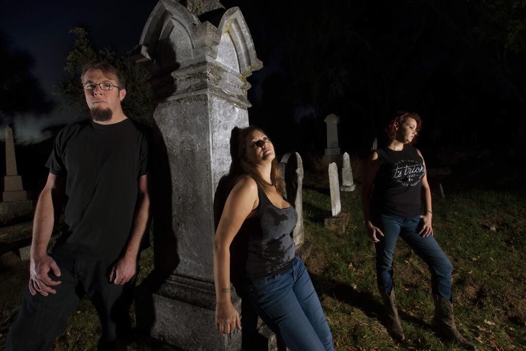 Members of the Nor-Cal Paranormal Research Society from left, John Lorence, Betsi Conner-Hamilton and Kary Lamaster-Monday where they often do their research at the Cloverdale Cemetery in Cloverdale, California. October 20, 2018.(Photo: Erik Castro/for The Press Democrat)