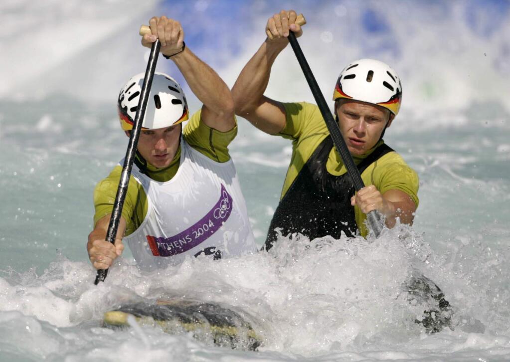 FILE - In this Aug. 19, 2004 file photo, Germany's Marcus Becker, left, and Stefan Henze, right, compete during a C2 men's canoe double category race at the Olympic Canoe-Kayak slalom venue of the Helliniko Sports Complex at the 2004 Olympic Games in Athens. The German Olympic team said Monday, Aug. 15, 2016, canoe slalom coach Henze has died from injuries sustained in a car crash last week in Rio de Janeiro. (AP Photo/Lefteris Pitarakis, File)