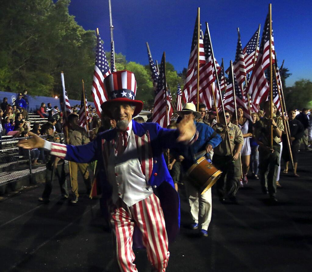 Uncle Sam leads the parade of flags at the July 3rd Fireworks and Music Extravaganza at Analy High School in Sebastopol. (JOHN BURGESS / The Press Democrat)