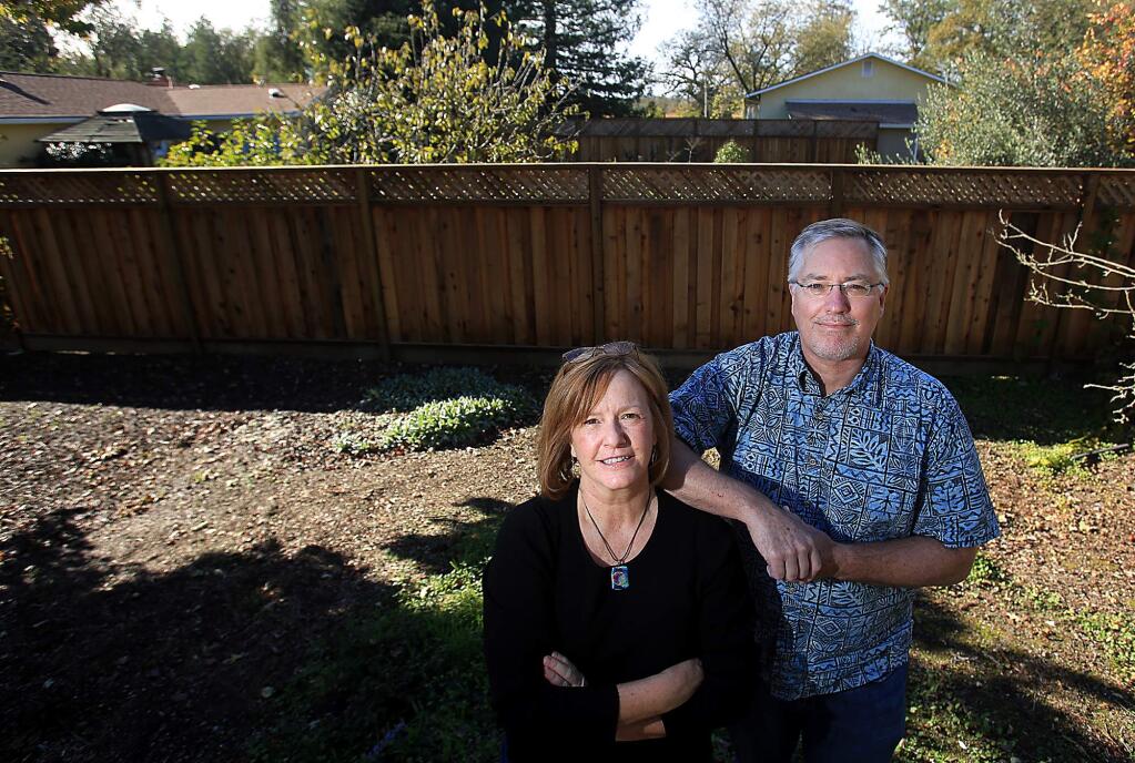 Kathleen and Michael Whitener of Santa Rosa live next door to an indoor pot grow that is ringed with tall fences, security cameras and bright outdoor lighting, Friday Dec. 1, 2016. (Kent Porter / The Press Democrat) 2016