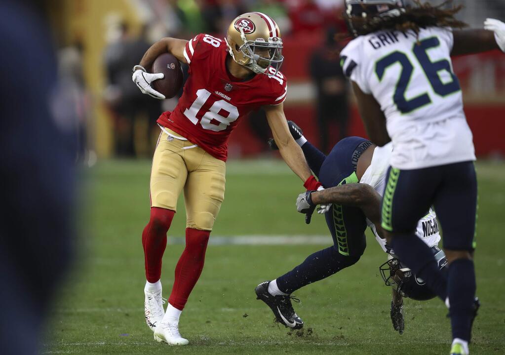 FILE - In this Dec. 16, 2018, file photo, San Francisco 49ers wide receiver Dante Pettis (18) runs against the Seattle Seahawks during the second half of an NFL football game in Santa Clara, Calif. The one benefit for Pettis during a disappointing start to his rookie season for the 49ers a year ago was that the knee injury that limited his playing time allowed him to learn the offense better. (AP Photo/Ben Margot, File)