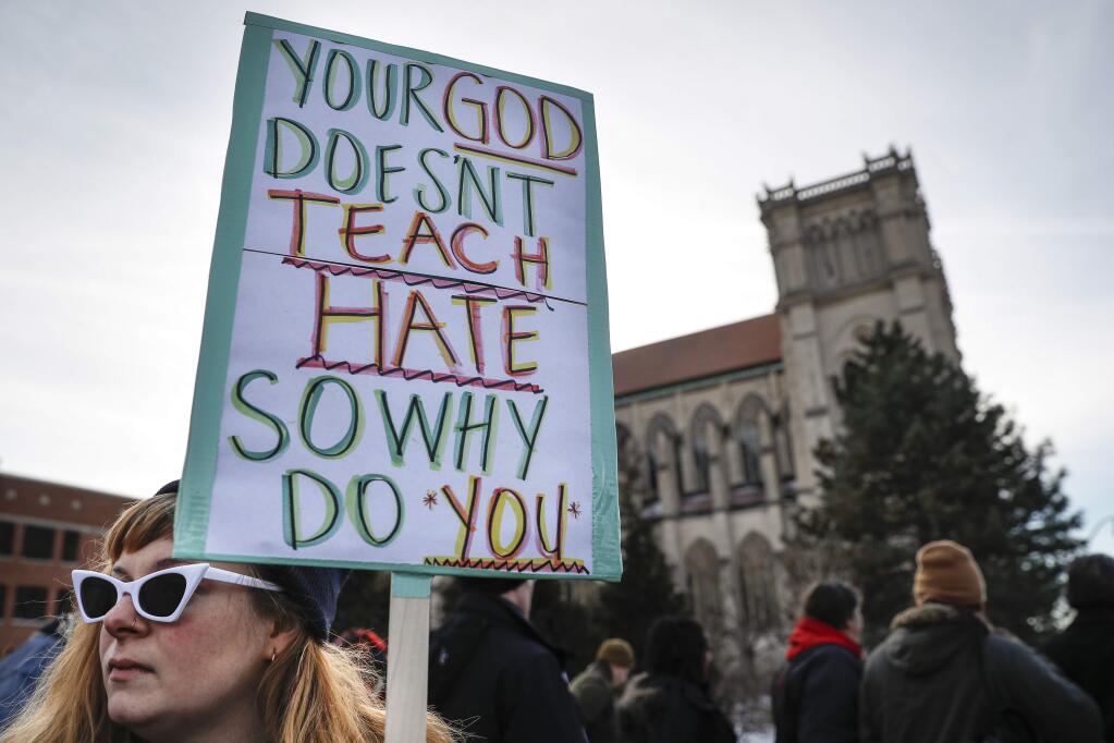 Protestors gather outside the Catholic Diocese of Covington Tuesday, Jan. 22, 2019, in Covington, Ky. The diocese in Kentucky has apologized after videos emerged showing students from Covington Catholic High School mocking Native Americans outside the Lincoln Memorial on Friday after a rally in Washington. (AP Photo/John Minchillo)