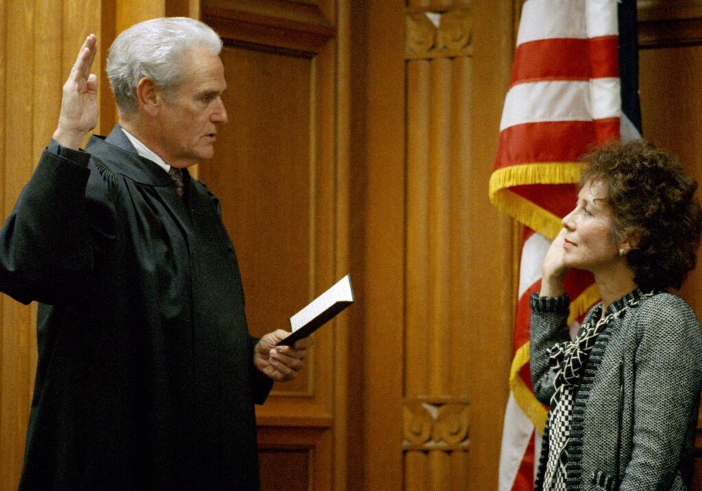 FILE - In this April 5, 1989, file photo, then California Supreme Court Justice Malcolm Lucas, left, swears in Supreme Court Justice Joyce Kennard after she was confirmed by a state commission, in Los Angeles, Calif. Former California Supreme Court Chief Justice Malcolm Lucas, who took the court's helm after three justices were voted out during a stormy period in the 1980s, has died. He was 89. Lucas died Wednesday, Sept. 28, 2016, at home in Los Angeles after battling cancer since early this year, his family said. (AP Photo/Alan Greth, File)