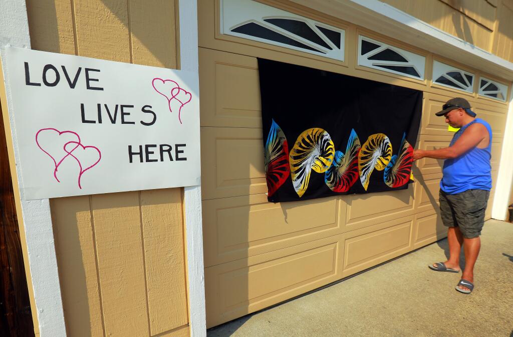 Bentley Chan's neighbors on Bentley Place in Santa Rosa have organized a block party on Sunday to paint over racial graffiti sprayed on the garage door of the Chinese-Fijian immigrant and his family's home. Neighbors covered up the graffiti and added signs of support and love for the family. (photo by John Burgess/The Press Democrat)