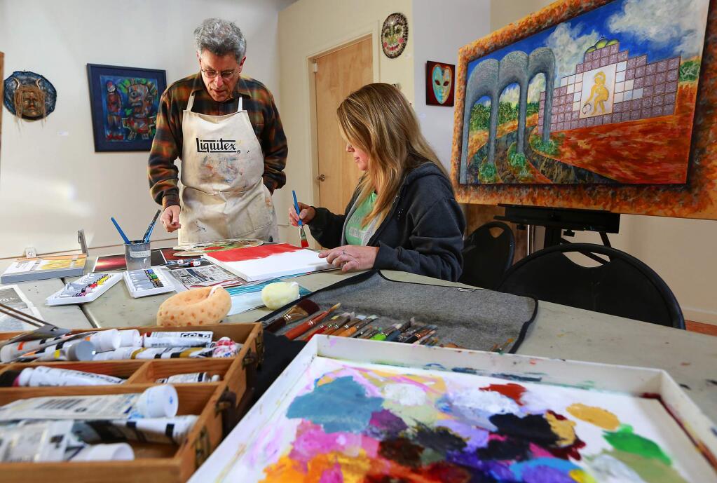 Art instructor Simmon Factor works with Toni Dufford in his beginning painting class at the Chroma Gallery in the South A Street district of Santa Rosa. (JOHN BURGESS/ PD)