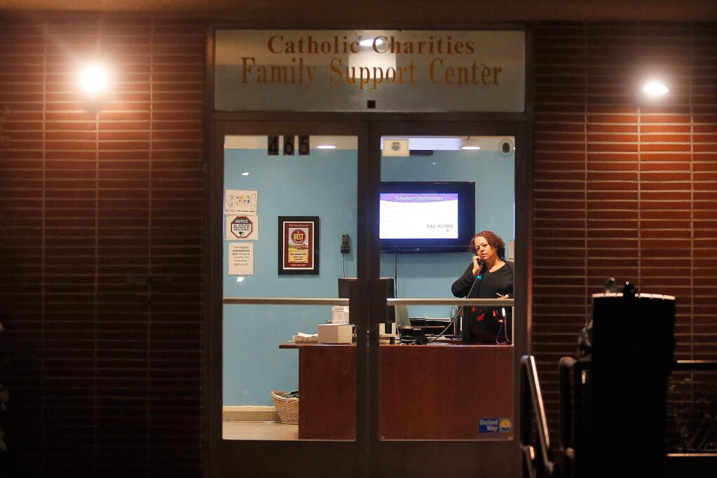 Staffer Leslie Lawson answers the telephone at the front desk of the Catholic Charities Family Support Center in Santa Rosa, California, on Thursday, February 15, 2018. (Alvin Jornada / The Press Democrat)