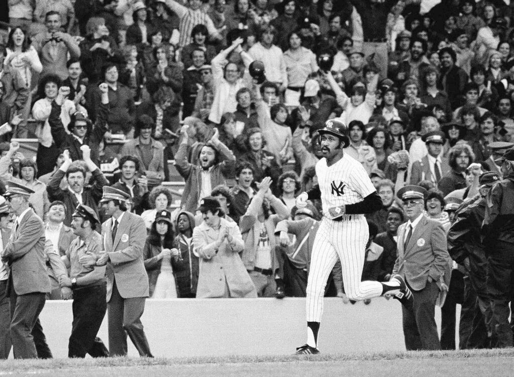 FILE - In this June 6, 1976, file photo, New York Yankees' Oscar Gamble heads for home plate after hitting a ninth inning home run to beat the Oakland A's 5-2 in the second baseball game of a doubleheader at Yankee Stadium in New York. Gamble, an outfielder who hit 200 home runs over 17 major league seasons, died Wednesday, Jan. 31, 2018, of a rare tumor of the jaw. He was 68. (AP Photo/Ray Stubblebine, File)
