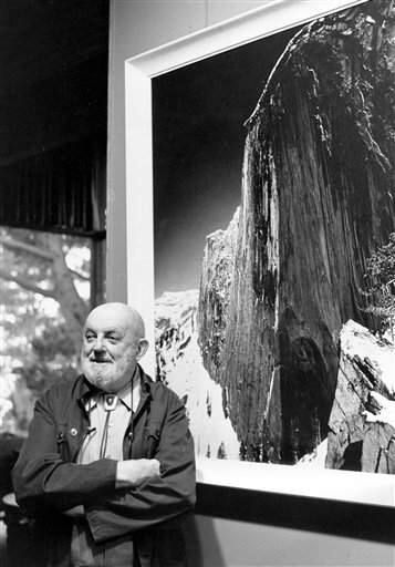 In this Dec. 2,1980 file photo showing late photographer, Ansel Adams posing in front of his photograph of one the views of Yosemite National Park titled 'Monolith: The Face of Half Dome, 1927,' in his home in Carmel Highlands, Calif. (AP Photo/Paul Sakuma,File)