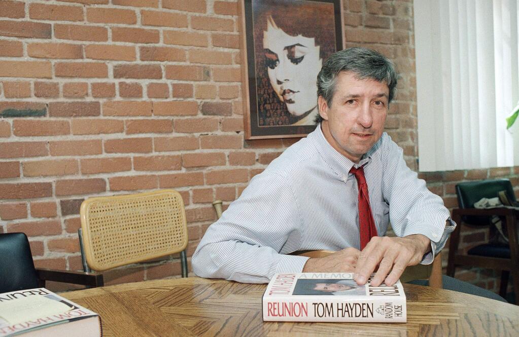 FILE - In this June 6, 1988 file photo, Tom Hayden talks about his new book, 'Reunion,' during a interview at his office in Santa Monica, Calif. Hayden, the famed 1960s anti-war activist who moved beyond his notoriety as a Chicago 8 defendant to become a California legislator, author and lecturer, has died. He was 76. His wife, Barbara Williams, says Hayden died on Sunday, Oct. 23, 2016, in Santa Monica of a long illness. (AP Photo/Lennox McLendon, File)