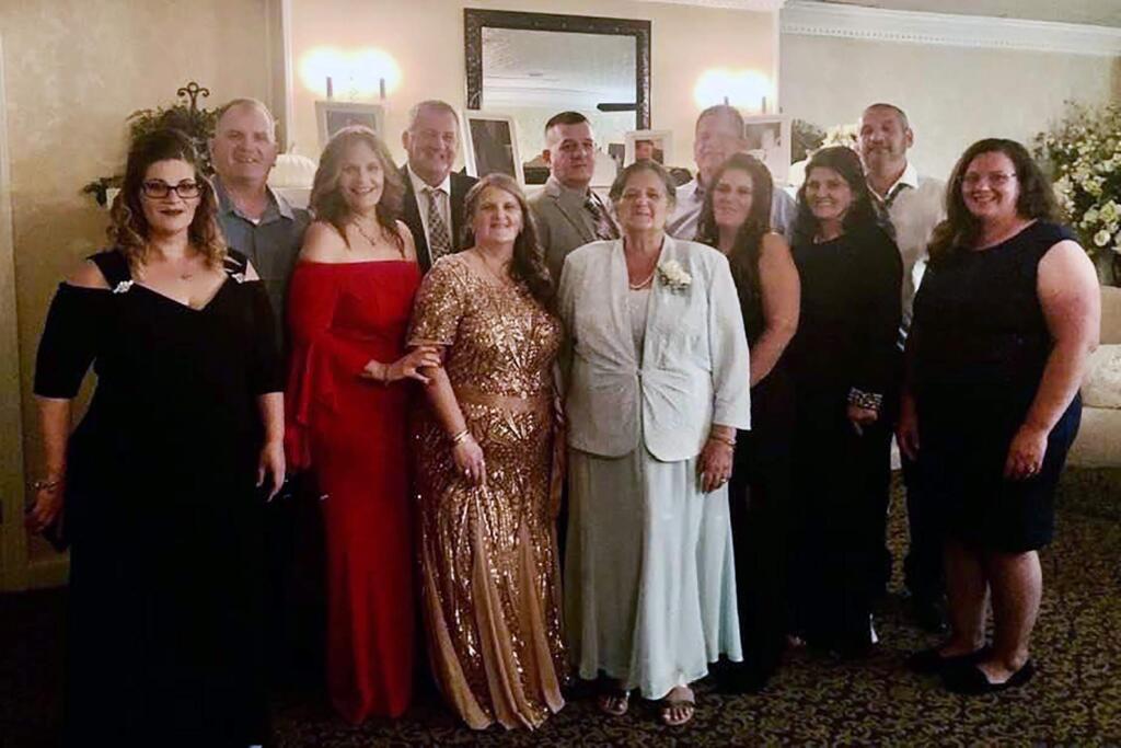 An undated family photo shows Grace Fusco, center, and her 11 children. Fusco, 73, died on Wednesday night, March 18, 2020, after contracting the coronavirus - hours after her son died from the virus and five days after her daughter's death, a relative said. (Courtesy of The Fusco Family via The New York Times) -- NO SALES; FOR EDITORIAL USE ONLY WITH NYT STORY SLUGGED NJ-VIRUS BY TRACEY TULLY FOR MARCH 19, 2020. ALL OTHER USE PROHIBITED. --