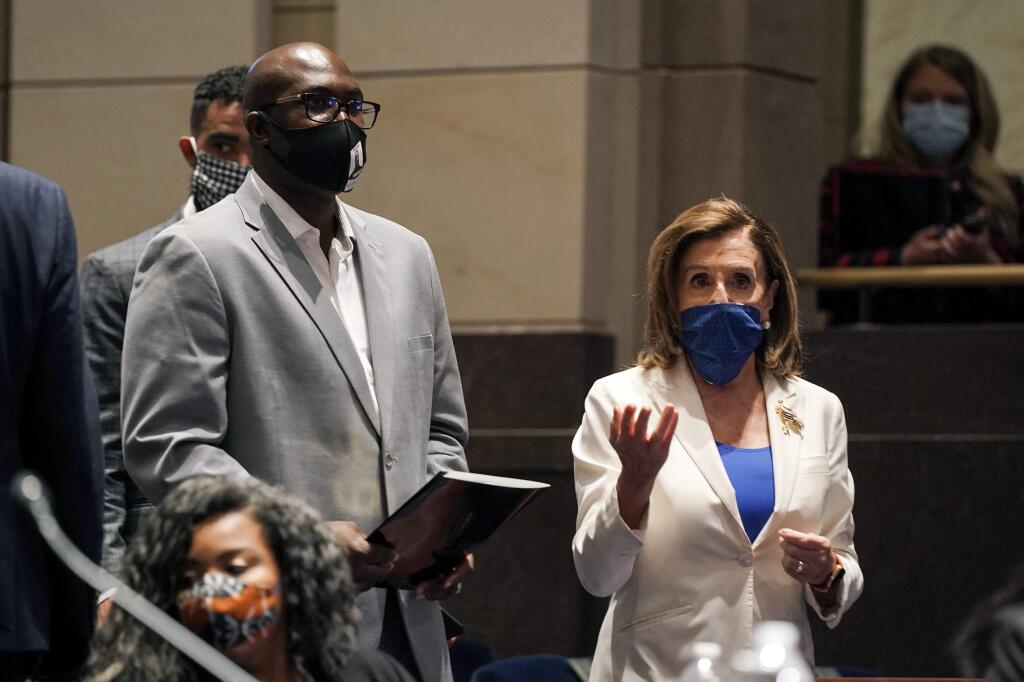 Philonise Floyd, a brother of George Floyd, and House Speaker Nancy Pelosi of Calif., arrive for a House Judiciary Committee hearing on proposed changes to police practices and accountability on Capitol Hill, Wednesday, June 10, 2020, in Washington. (Greg Nash/Pool via AP)