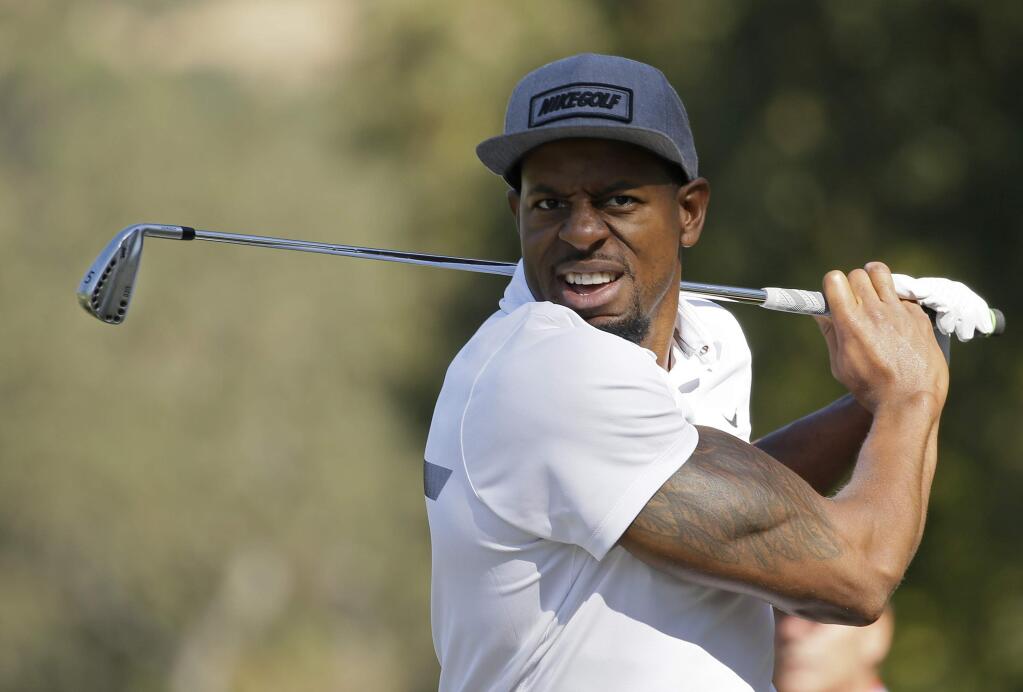 In this Oct. 12, 2016, file photo, the Golden State Warriors' Andre Iguodala follows his shot from the 16th fairway of the Silverado Resort North Course during the pro-am event of the Safeway Open PGA golf tournament in Napa. Iguodala's second passion is golf. He's putting that to work at the PGA Championship by doing reporting for Turner Sports. (AP Photo/Eric Risberg, File)