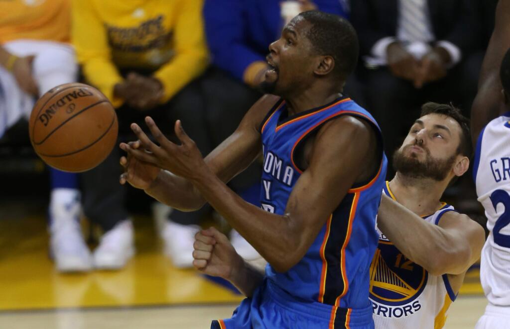 Oklahoma City Thunder's Kevin Durant loses the ball as he's fouled by Golden State Warriors' Andrew Bogut, during their game in Oakland on Thursday, May 26, 2016. The Warriors defeated the Thunder 120-111.(Christopher Chung/ The Press Democrat)