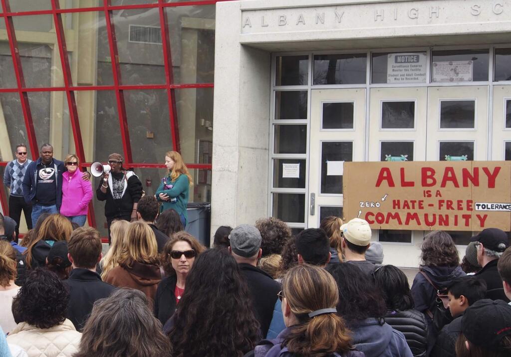In this March 26, 2017 photo, people attend a rally for the Albany for All to support unity and inclusiveness in response to racist and offensive posted on social media, at Albany High School in Albany, Calif. Four Albany High School students sued a school district after they were suspended over their responses to Instagram posts that included a black student and coach with nooses around their necks. (Chris Treadway/East Bay Times via AP)