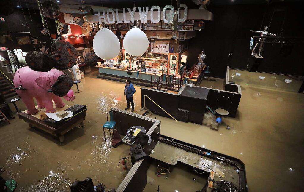 The Historic River Theater owned by Jerry Knight, sustained significant damage as the Russian River crested and poured in to the building along Main Street in Guerneville, late Wednesday and early Thursday, Feb. 28, 2019. Knight estimates that about seven feet of water inundate the dance floor, right. (KENT PORTER/PD)