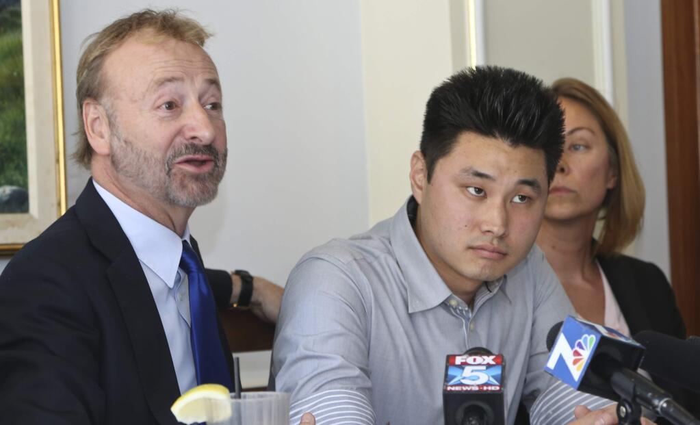 Attorney Gene Iredale, left, talk about the need for the Office of the Inspector General to release in full its findings regarding the incarceration of Daniel Chong, center, when he was held by the Drug Enforcement Administration for five days without food and water at a news conference Thursday, July 10, 2014, in San Diego. Chong is flanked by ACLU policy director Margaret Dooley-Sammuli. (AP Photo/Lenny Ignelzi)