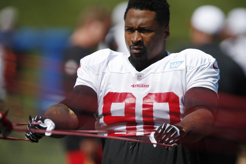 San Francisco 49ers defensive tackle Darnell Dockett uses bands to stretch while facing the Denver Broncos during a scrimmage Wednesday, Aug. 26, 2015, in Englewood, Colo. (AP Photo/David Zalubowski)