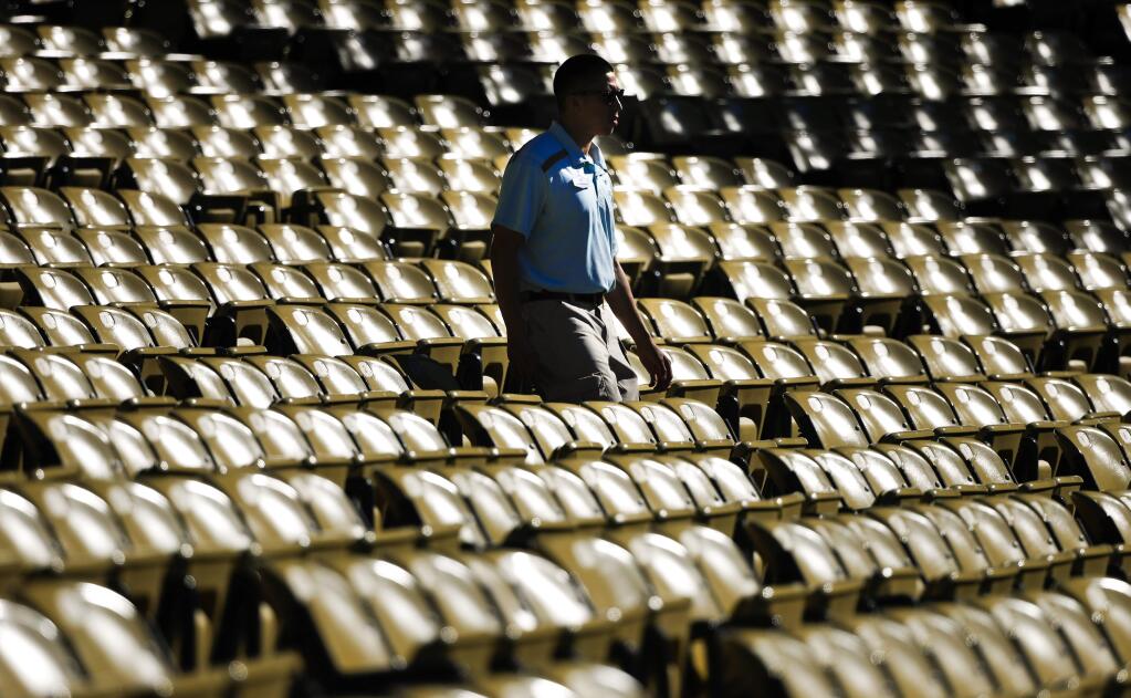 Seats glow in sunlight at Dodger Stadium, Tuesday, June 20, 2017, in Los Angeles. The first day of summer brought some of the worst heat the Southwest U.S. has seen in years, forcing flights to be canceled, straining the power grid and making life miserable for workers toiling in temperatures that reached 120 degrees in some desert cities. (AP Photo/Jae C. Hong)