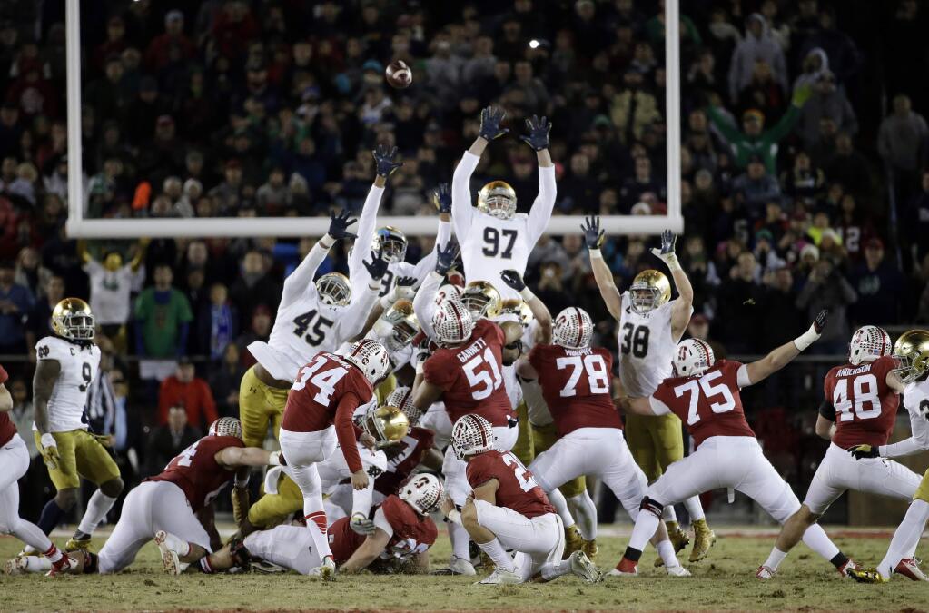 Stanford's Conrad Ukropina (34) hits a 45-yard field goal as time expires to give Stanford a 38-36 win over Notre Dame Saturday, Nov. 28, 2015. (AP Photo/Marcio Jose Sanchez)