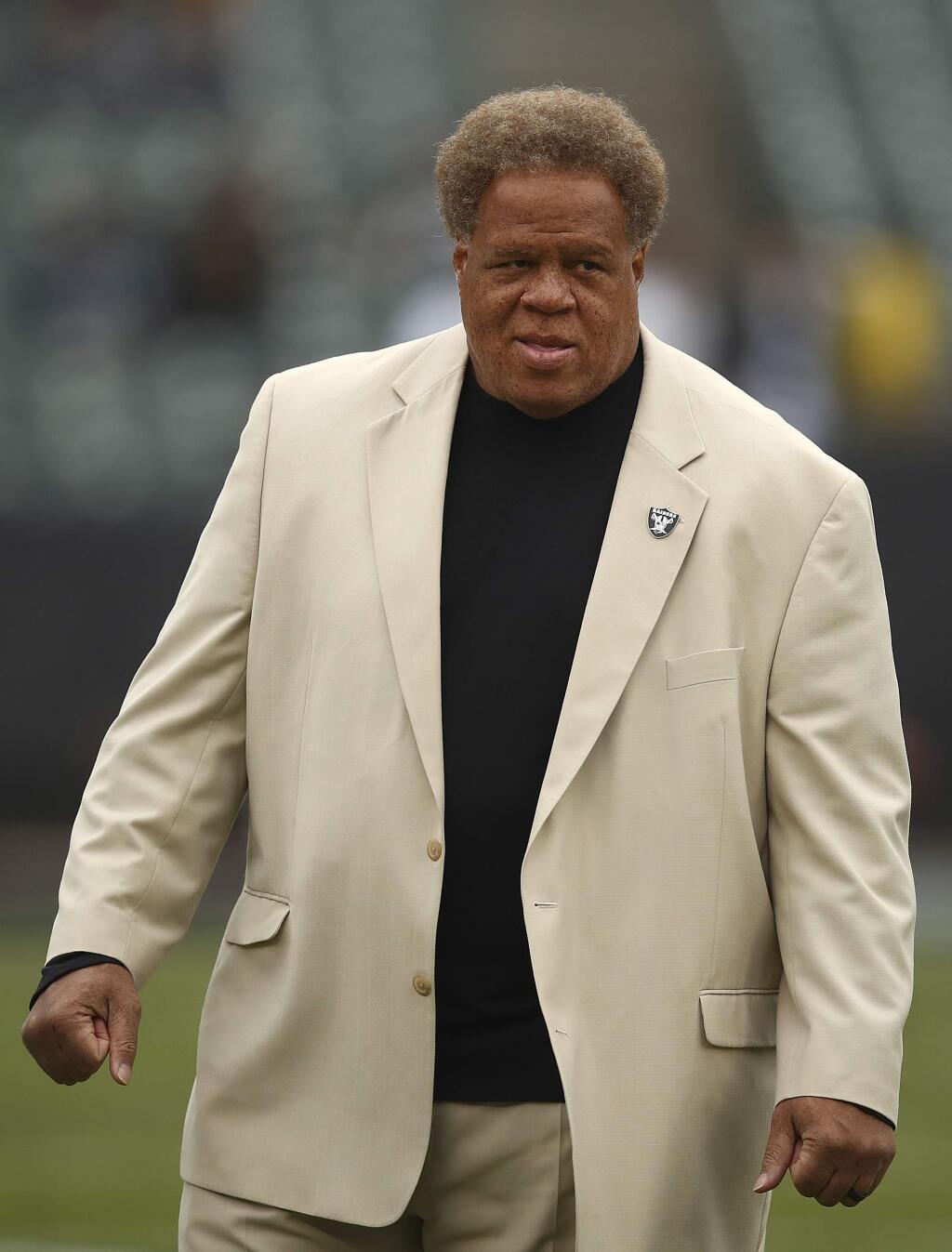 FILE - In this Dec. 9, 2018, file photo, Oakland Raiders general manager Reggie McKenzie stands on the field before an NFL football game between the Raiders and the Pittsburgh Steelers in Oakland, Calif. (AP Photo/Ben Margot, File)