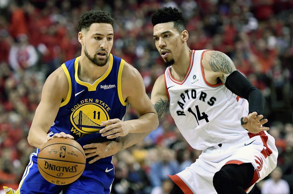 Toronto Raptors guard Danny Green (14) pressures Golden State Warriors guard Klay Thompson (11) as he drives down court during the first half of Game 2 of the NBA Finals, Sunday, June 2, 2019, in Toronto. (Frank Gunn/The Canadian Press via AP)