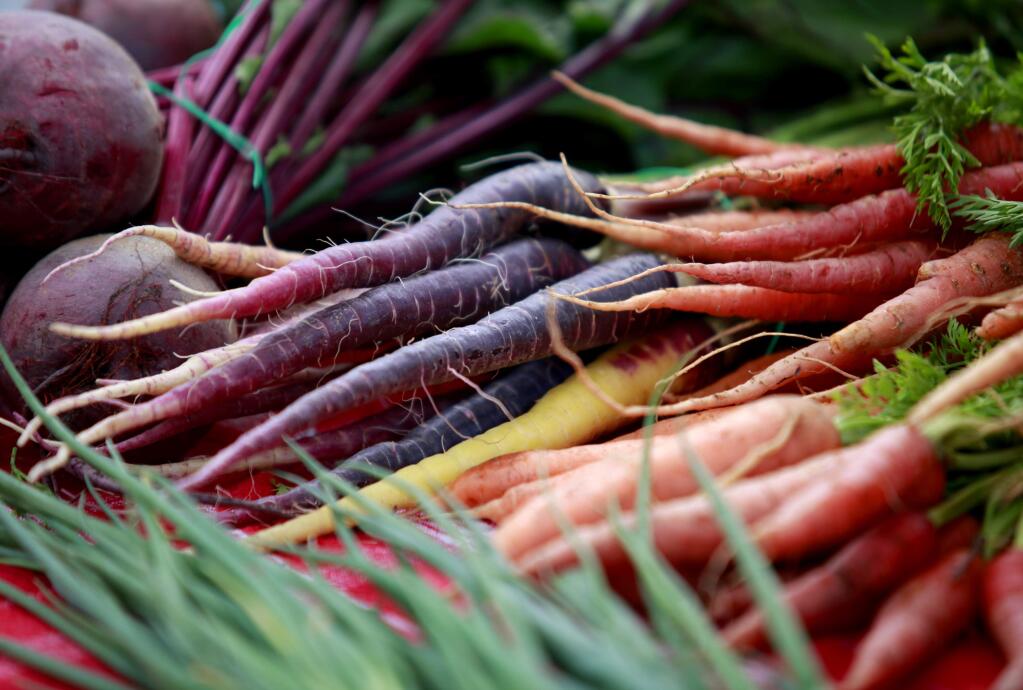 A colorful variety of carrots are for sale at the Petaluma East-Side Farmers Market at Lucchesi Park on Tuesday, April 28, 2015 in Petaluma, California . (BETH SCHLANKER/ The Press Democrat)