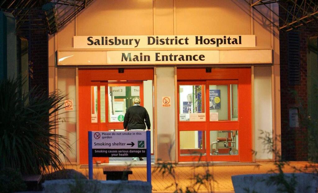 FILE - This is a Aug. 16, 2005 file photo of the main entrance of Salisbury District Hospital, in Salisbury, England. British media say a former Russian spy is in critical condition after coming into contact with an 'unknown substance.' Authorities did not identify the man, but the Press Association and other British media identified him Monday, March 5, 2018 as Sergei Skripal who was convicted in 2006 on charges of spying for Britain and sentenced to 13 years but was freed in 2010 in a U.S.-Russian spy swap. (Tim Ockenden/PA via AP, File)
